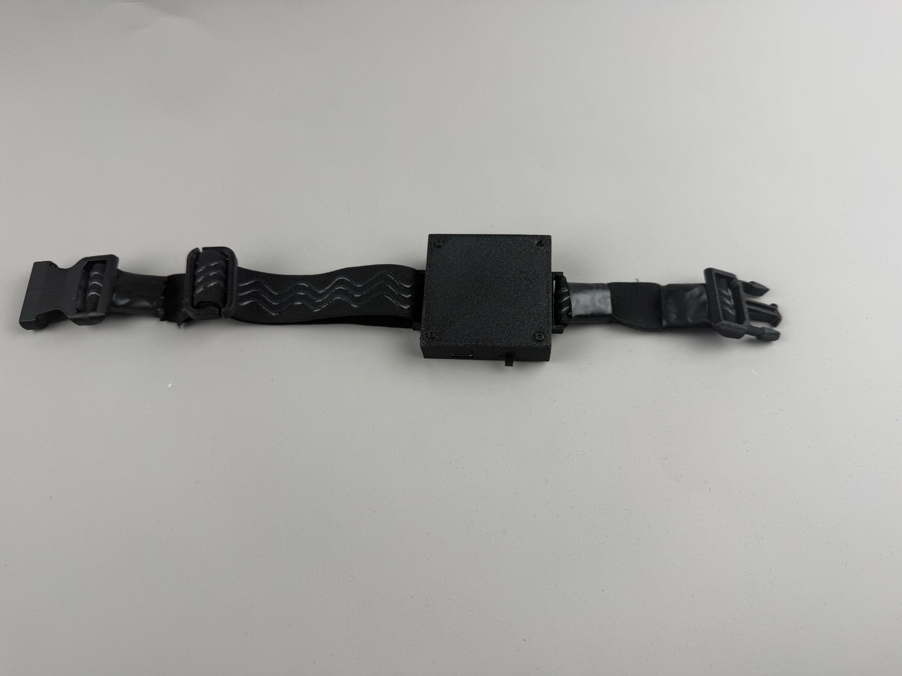 Closed DIY SlimeVR tracker mounted on an elastic strap